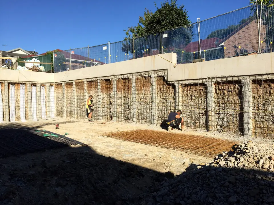 Crew fixing mesh between piles before shotcrete